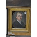 A 19th century English School, head and shoulders portrait of a young man in a Verre Eglomise and