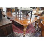 A Victorian mahogany extending dining table with three leaves on turned octagonal baluster shaped