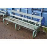 A large wrought iron and wooden garden bench (some wooden parts rotten).