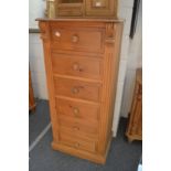 A tall pine six drawer chest.