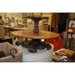 An oak two tier lazy susan with carved base.