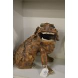 A grotesque pottery model of a lion dog.