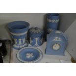 A group of blue jasperware items to include a mantle clock, vases etc.