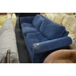 A dark blue upholstered two seater settee.