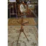 An unusual late Victorian oak shaving stand, the mirror and shelf modelled as horseshoes.