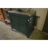 A painted metal storage cupboard.