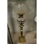 A brass corinthian column oil lamp.