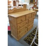 A large modern pine chest of drawers.