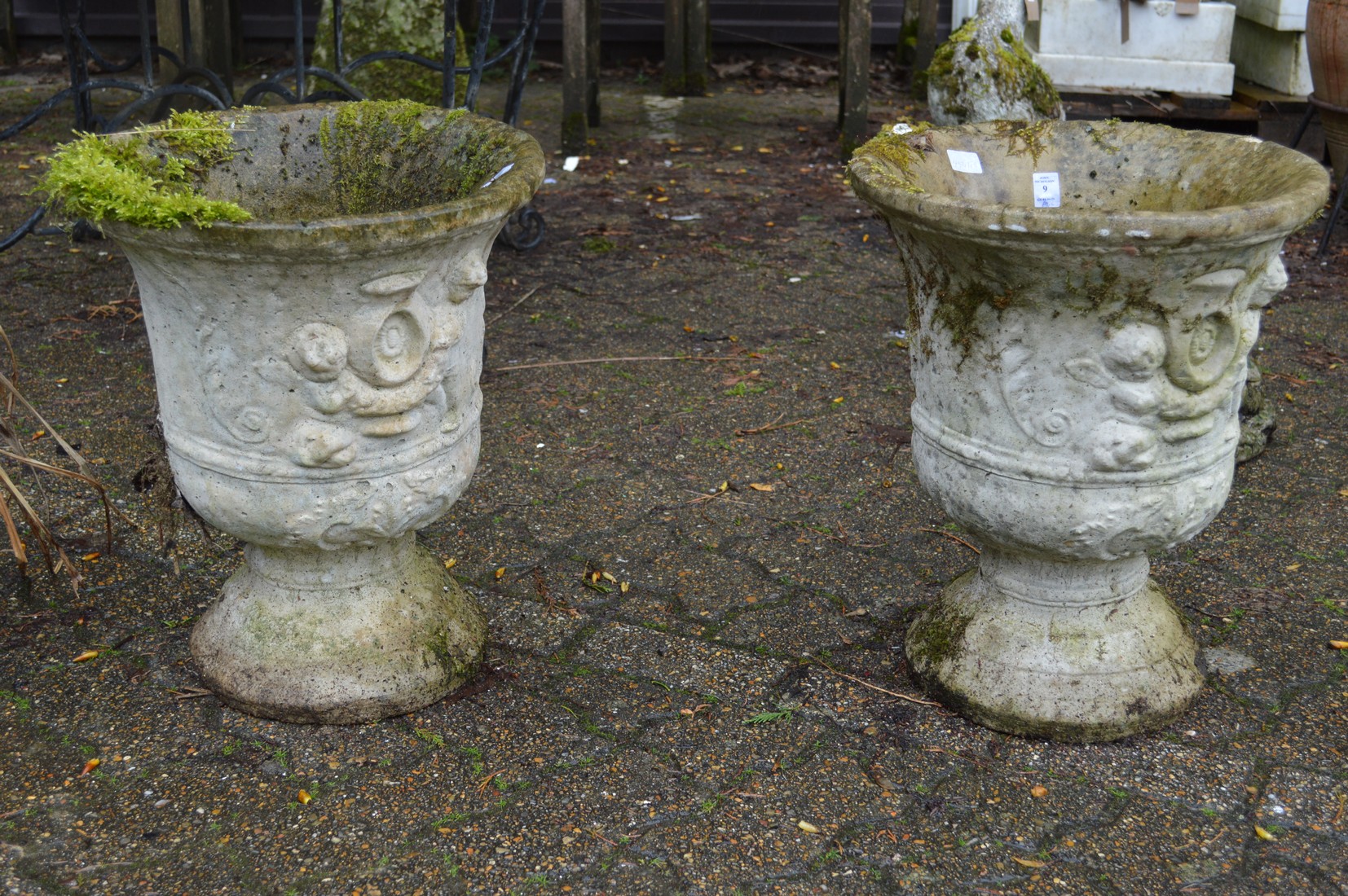 A pair of composite garden urns.