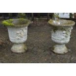 A pair of composite garden urns.