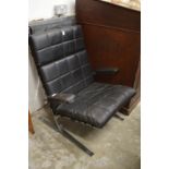 A stylish chrome framed and leather armchair.