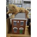 A dolls house and a cuddly toy/pyjama case.