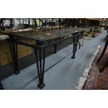 A modern glass top coffee table with black painted metal frame.