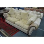 A large suede and leather upholstered two seater settee.