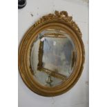 A good gilt framed circular wall mirror with decorative mouldings.