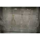 A good group of glassware to include three decanters, claret jug, large cut glass jug, pair of