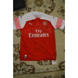 An official signed Arsenal football club shirt, with original box and certificate.