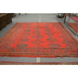 A Turkish carpet, bright red ground with stylised decoration, worn 356cm x 356cm.