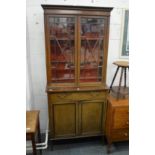 An Edwardian inlaid mahogany cupboard bookcase.