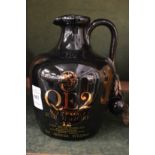 A pottery jug containing QE2 single malt scotch whisky.