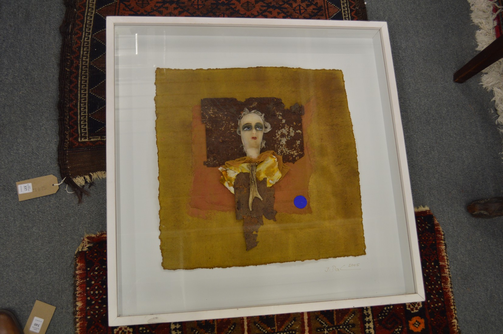 Abstract collage of a bust of a person, framed and glazed.
