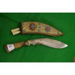 A miniature Kukri with decorative scabbard.