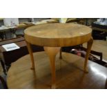 A walnut circular coffee table.