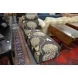 An upholstered daybed ottoman.