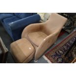 A stylish armchair with matching foot stool.