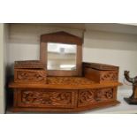 An Eastern carved hardwood dressing table mirror with storage boxes and drawers.