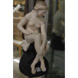 A Continental bisque porcelain model of a seated female nude.