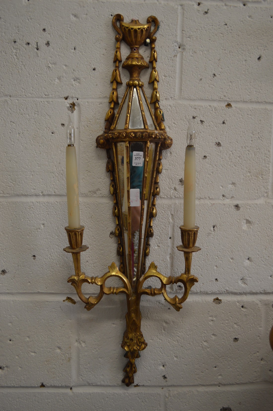 A pair of decorative gilt and mirrored two branch wall appliques.