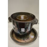 A plated champagne bucket with rams horn handles and two other items.