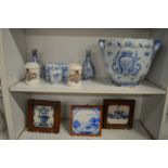 A delft twin handled jardiniere and similar items to include a flower brick and three framed tiles.