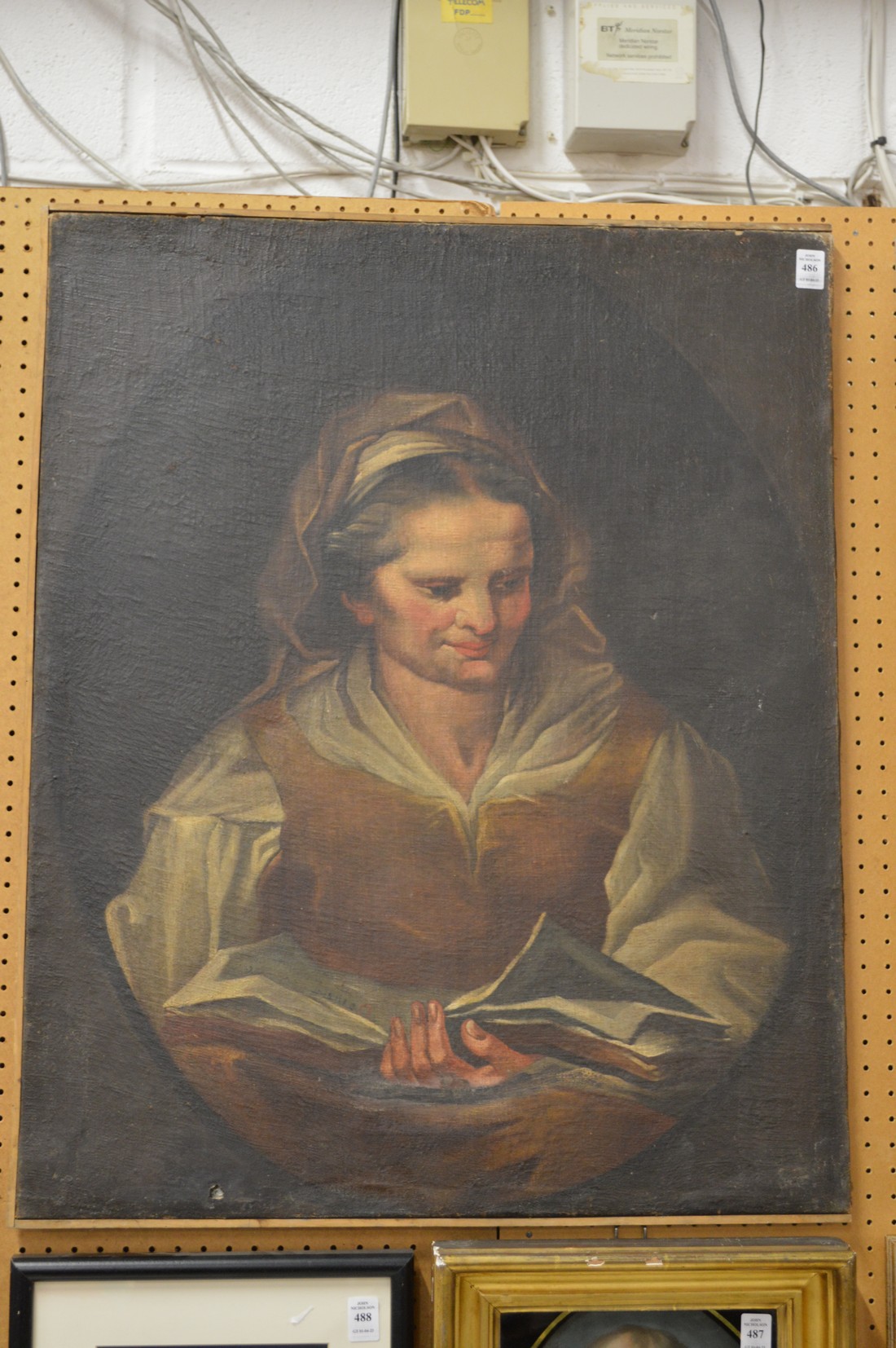Manner of Nogari, portrait of a lady reading a book, oil on canvas, unframed.
