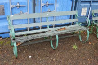 A large wrought iron and wooden garden bench (some wooden parts rotten).