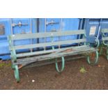 A large wrought iron and wooden garden bench (some wooden parts rotten).