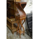 A stylish carved wood table or stand with similar base.