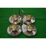 A stylish four piece egg cruet and stand.