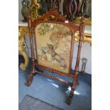 A good Victorian walnut firescreen, the central embroidered panel depicting two dogs.