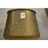 An Islamic engraved brass bowl.