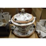 A large tureen cover and stand.
