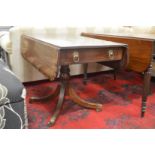 A Regency mahogany and rosewood banded pedestal pembroke table.