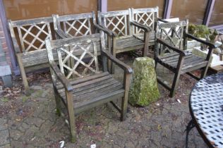 A set of six weathered teak garden armchairs.