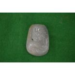 A Chinese carved jade amulet.