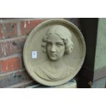 A composite relief cast art nouveau style circular plaque depicting the bust of a young lady.