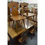 An unusual Swiss walnut dining room suite comprising: drawleaf table, ten chairs, two with arms,
