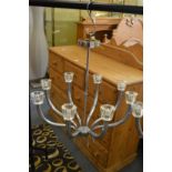A stylish chrome plated eight branch chandelier.
