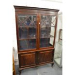 A mahogany cupboard bookcase.