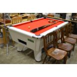 A Supreme pool table with accessories.